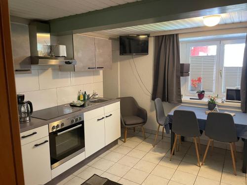 a kitchen with a table and a dining room at Wasserfall in Stall