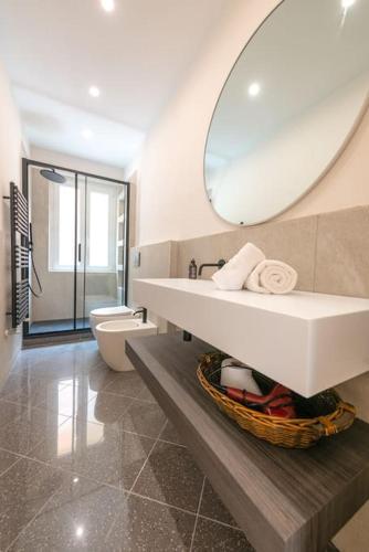 a bathroom with a sink and a toilet and a mirror at Ca' Disa - Loft moderno centro città in Rapallo