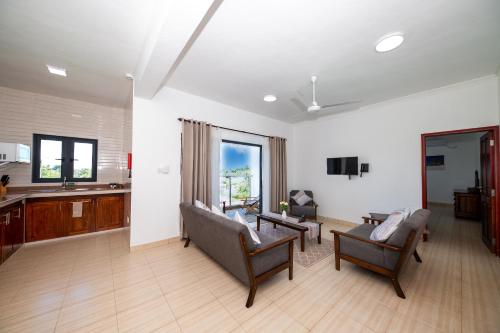 a living room with a couch and a table at Bijoutier Apartments in Grand'Anse Praslin