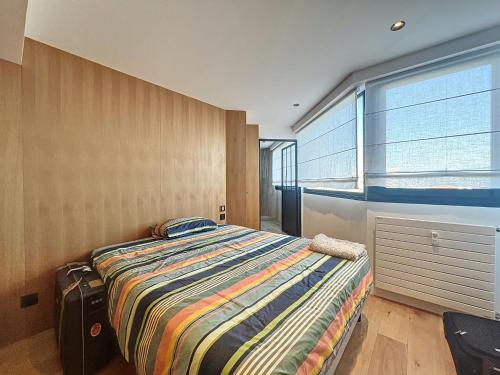 une chambre avec un lit et une grande fenêtre dans l'établissement Neptunia, à Antibes