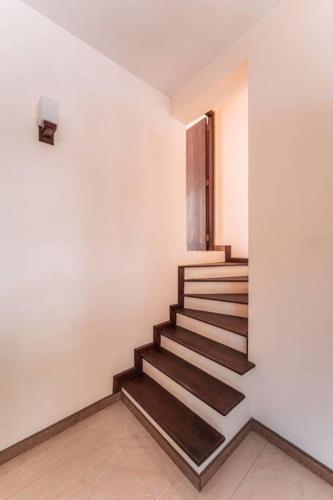 a staircase in a white room with a stair case at Amfa Apartment in Ratmalana