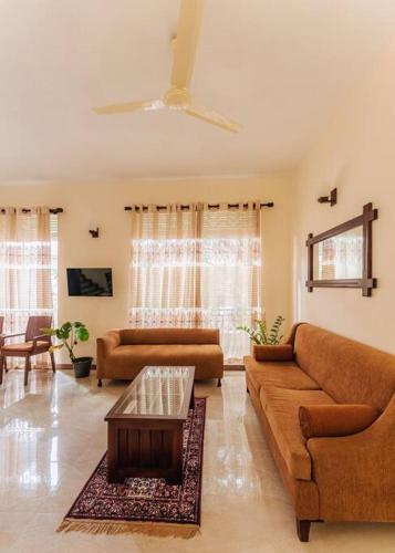 a living room with two couches and a coffee table at Amfa Apartment in Ratmalana