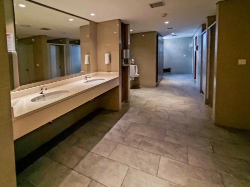 a large bathroom with two sinks and a large mirror at Borneo Bay City Apartment, 1BR in Klandasan Kecil