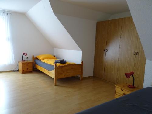 a bedroom with a bed and a wooden cabinet at Futterküche in Haselünne