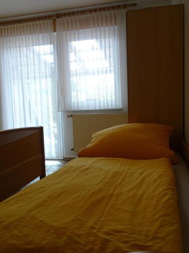 a bedroom with a large bed and two windows at Pferdestall in Haselünne