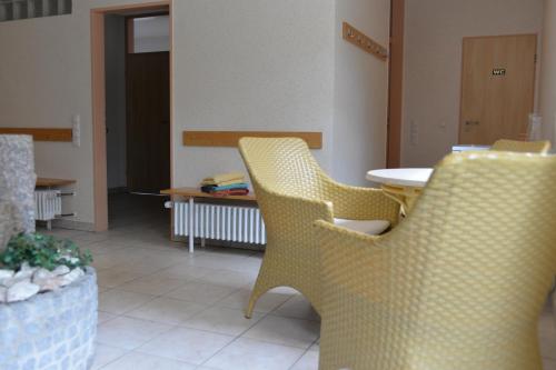 two yellow chairs and a table in a room at Pferdestall in Haselünne