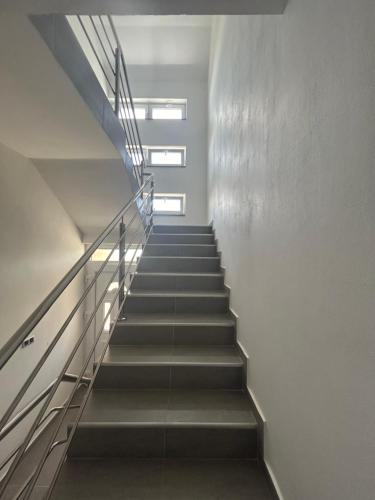 a staircase in a building with two windows at Apartments Nicole Wera in Nin