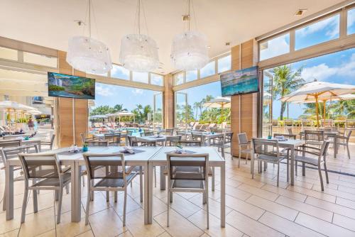 um restaurante com mesas e cadeiras e uma piscina em Hyatt Regency Waikiki Beach Resort & Spa em Honolulu