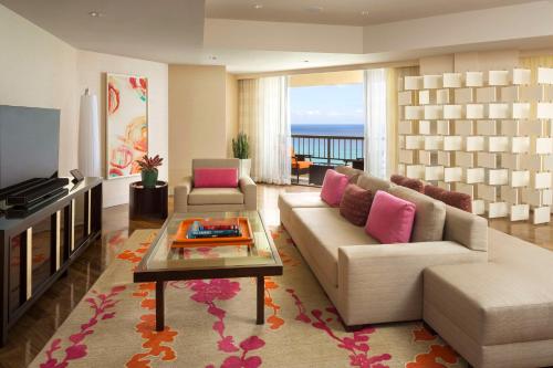 - un salon avec un canapé et une table dans l'établissement Hyatt Regency Waikiki Beach Resort & Spa, à Honolulu