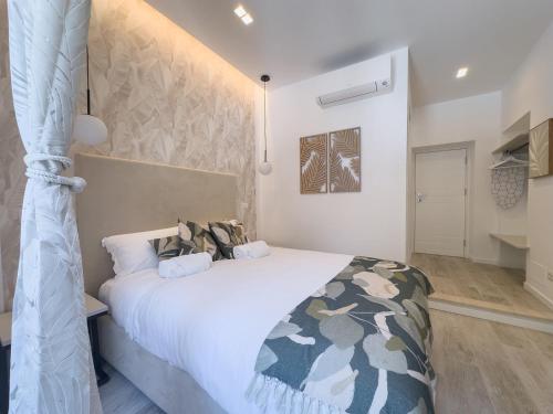 a bedroom with a large white bed in a room at White Ottaviano in Rome