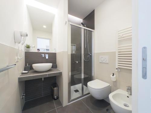 a bathroom with a toilet and a sink and a shower at White Ottaviano in Rome