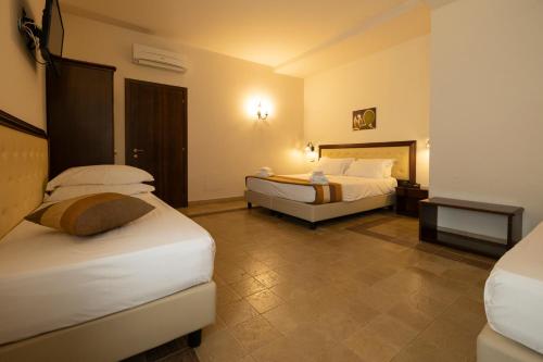 a hotel room with two beds in a room at Badiula in Carlentini