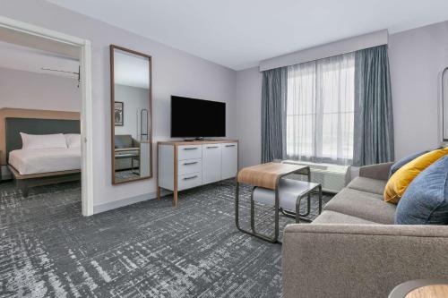 a hotel room with a bed and a television at Homewood Suites - Rock Springs in Rock Springs