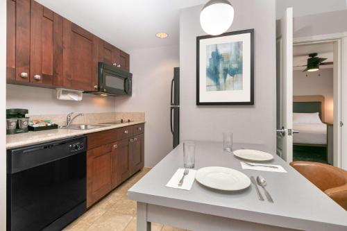 a kitchen with a table with two plates on it at Homewood Suites - Rock Springs in Rock Springs