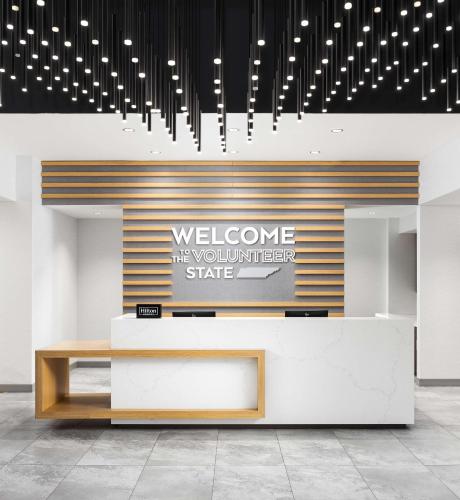 a lobby with a reception desk and chandeliers at Hampton Inn Knoxville-West At Cedar Bluff in Knoxville