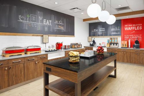 a large kitchen with a table in the middle at Hampton Inn Knoxville-West At Cedar Bluff in Knoxville