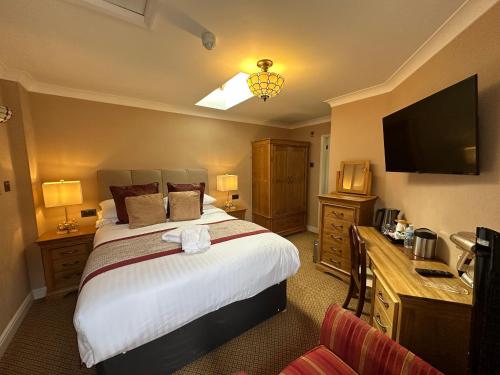 a hotel room with a bed and a television at Chester House Guest House in Chester