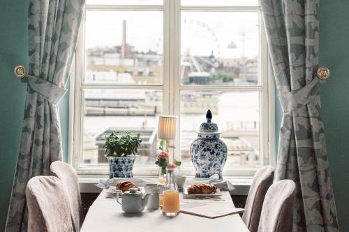 a dining room table with a view of a window at Hotel Haven in Helsinki