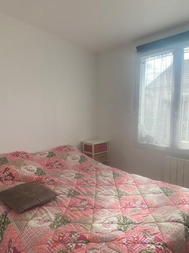 En eller flere senge i et værelse på Appartement - Villa Muguet