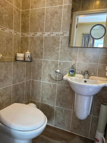 a bathroom with a toilet and a sink at Chester House Guest House in Chester