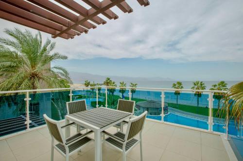 a table and chairs on a balcony with a view of the ocean at Radisson Blu Resort, Fujairah in Dibba