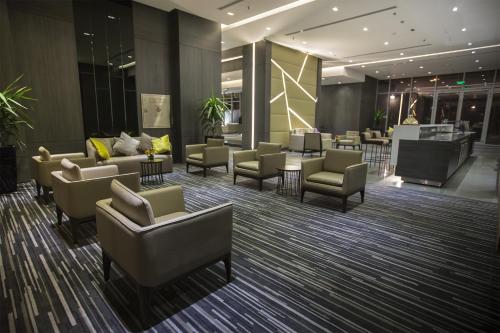 a waiting room with couches and chairs in a building at Executives Hotel - KAFD in Riyadh