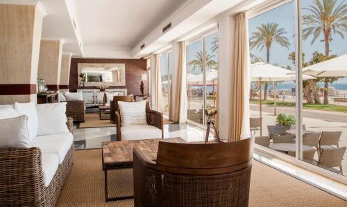 a living room with a view of the ocean at Catalonia del Mar - Adults Only in Cala Bona