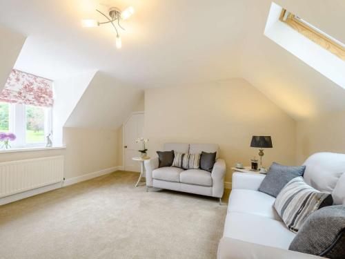 a living room with two white couches and a window at 1 Bed in Langholm 83343 in Langholm