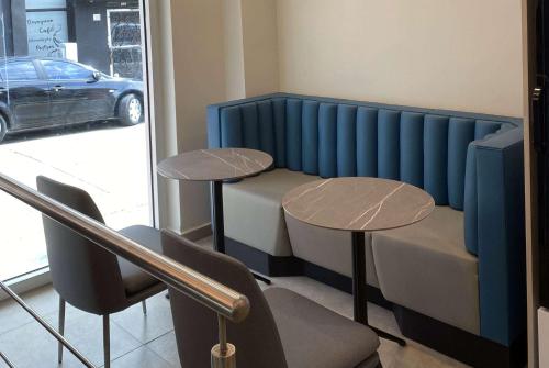 a room with two tables and a car outside a window at TRYP by Wyndham Mayaguez in Mayaguez