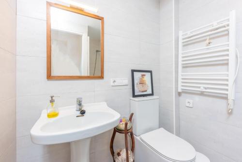 a bathroom with a sink and a toilet and a mirror at Cas Padrins -Portopetro- in Portopetro
