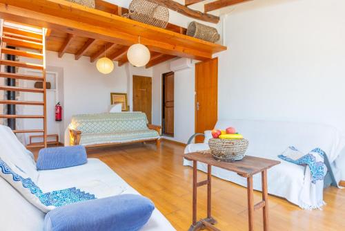 a living room with a couch and a table at Cas Padrins -Portopetro- in Portopetro