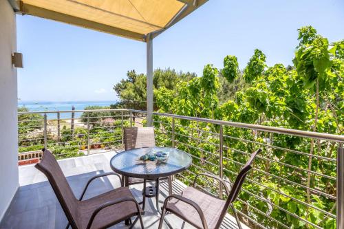 a balcony with a table and chairs and the ocean at Casa Di Mare - Studios and Apartments with pool on the beach, by ZanteWize in Vasilikos