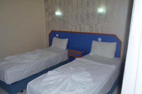 Ένα ή περισσότερα κρεβάτια σε δωμάτιο στο Dilhan Hotel