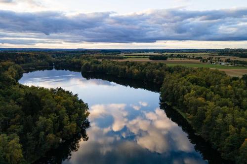 an aerial view of a river with clouds in the water at Tiny House Pioneer 1 - Salemer See in Salem