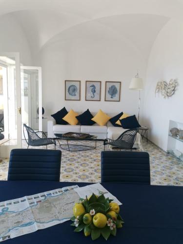 a living room with a table and chairs and a couch at Villa La Panoramica Sea View in Capri
