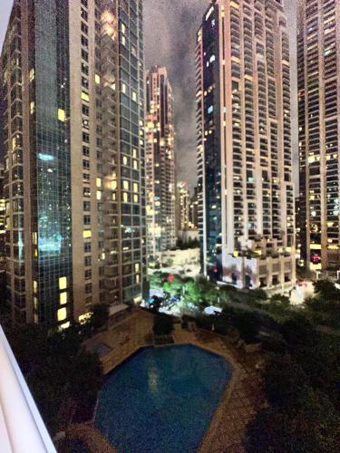 a view of a city at night with a pool at The residences 1 - Luxury 1BR apt in Downtown Dubai - 2 mins walk to Burj Khalifa & Dubai Mall in Dubai