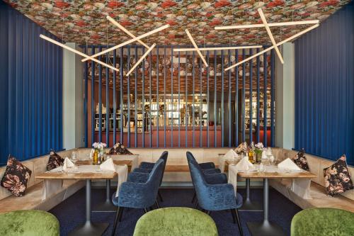 a rendering of a restaurant with tables and chairs at b-smart hotel Widnau in Widnau