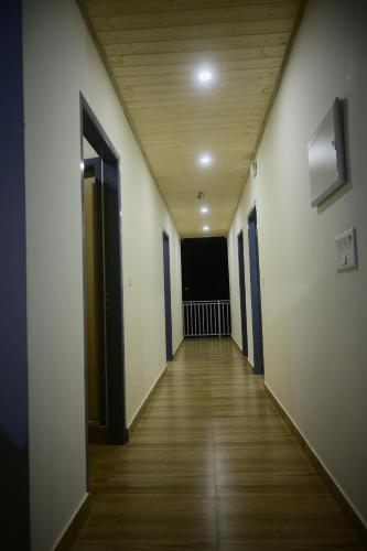 an empty hallway of an office building with a wooden floor at Saadhan Homestay in Mussoorie