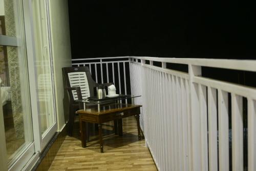 a porch with a piano and a chair on a balcony at Saadhan Homestay in Mussoorie