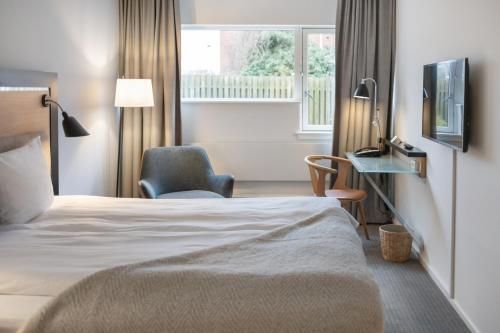 En eller flere senge i et værelse på Gentofte Hotel