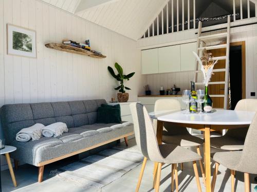 a living room with a couch and a table at Seaside Village House on Werder peninsula in Virtsu