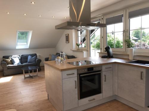 a kitchen with a sink and a living room at Ferienwohnung Am Spitalgarten für 4 Personen in Gundelfingen