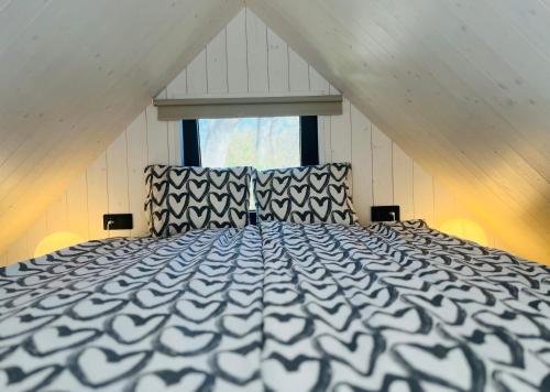 a bedroom with a large bed in a attic at Seaside Village House on Werder peninsula in Virtsu