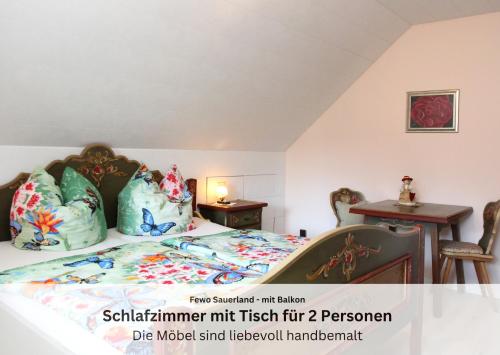 a bedroom with a bed with blue and white pillows at Ferienwohnungen Sauerland und Olsberg in Olsberg