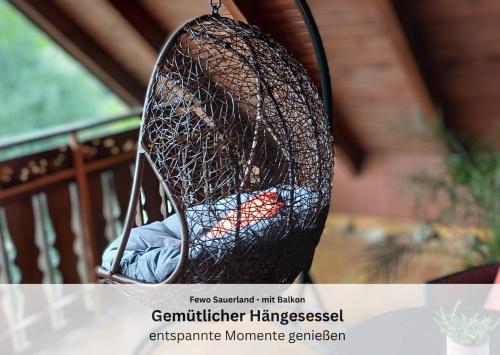 a bird cage hanging from a porch at Ferienwohnungen Sauerland und Olsberg in Olsberg