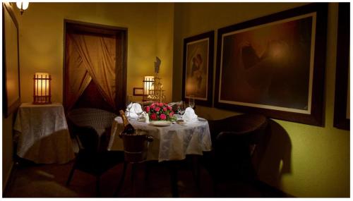 a dining room with a table with flowers on it at Neonz Resort & Club in Anand