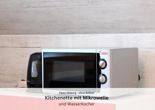 a microwave sitting on top of a counter at Ferienwohnungen Sauerland und Olsberg in Olsberg