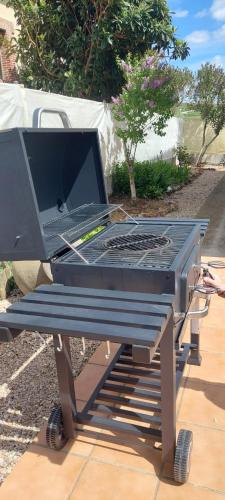 a grill on a picnic table with a laptop on it at Casa Rural Rincones de Albares in Albares