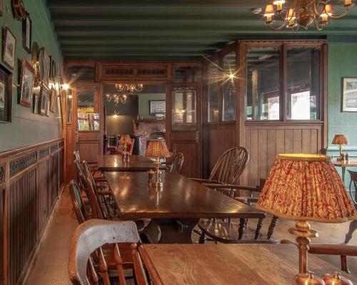 a dining room with wooden tables and chairs at Hotel Victoria in Whitby
