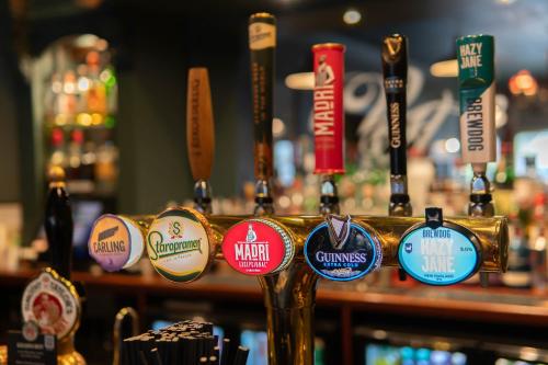 a bunch of pins on a bar with beers at Hotel Victoria in Whitby
